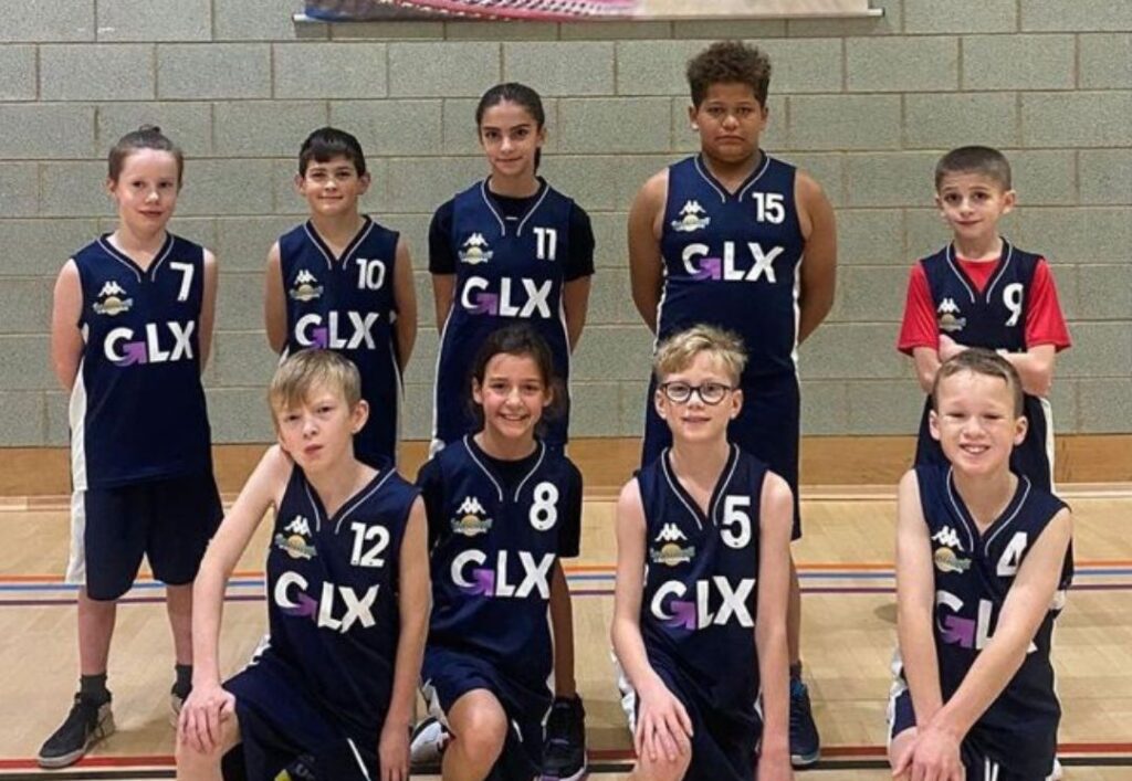 Basketball in the community team wearing GLX branded vests.