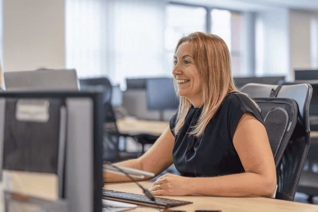 Kerry Porteous of GLX Advisory sits at her desk wearing a black top and looking at her computer screen which sits just out frame. This is a decorative image to support the Capital Gains Tax article.